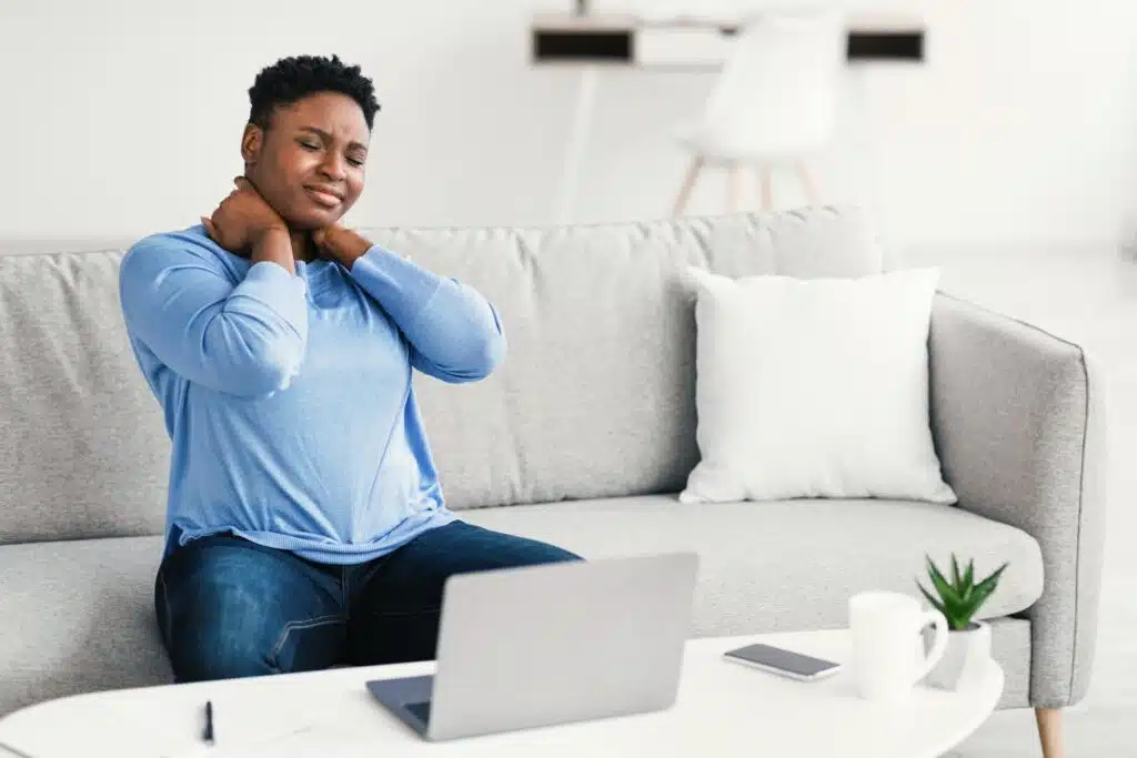 Portrait of black woman with neck pain after work