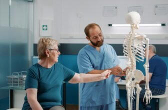 Osteopath explaining orthopedic diagnosis on human skeleton