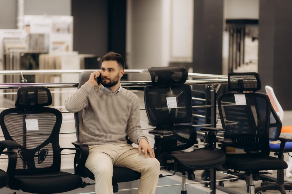 a man in a computer chair shop
