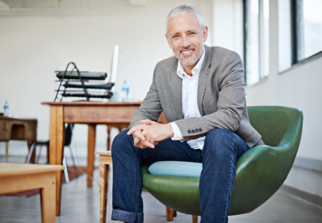 Cool, calm and collected. Portrait of a mature businessman sitting in a chair in an office.