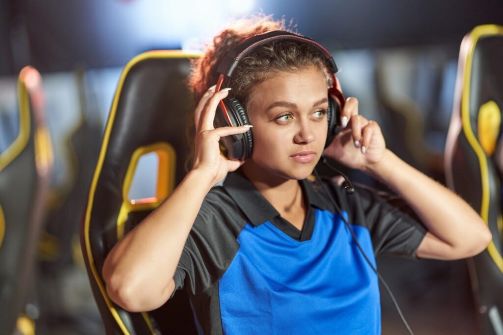 Teenage mixed race girl wearing headphones playing online video games