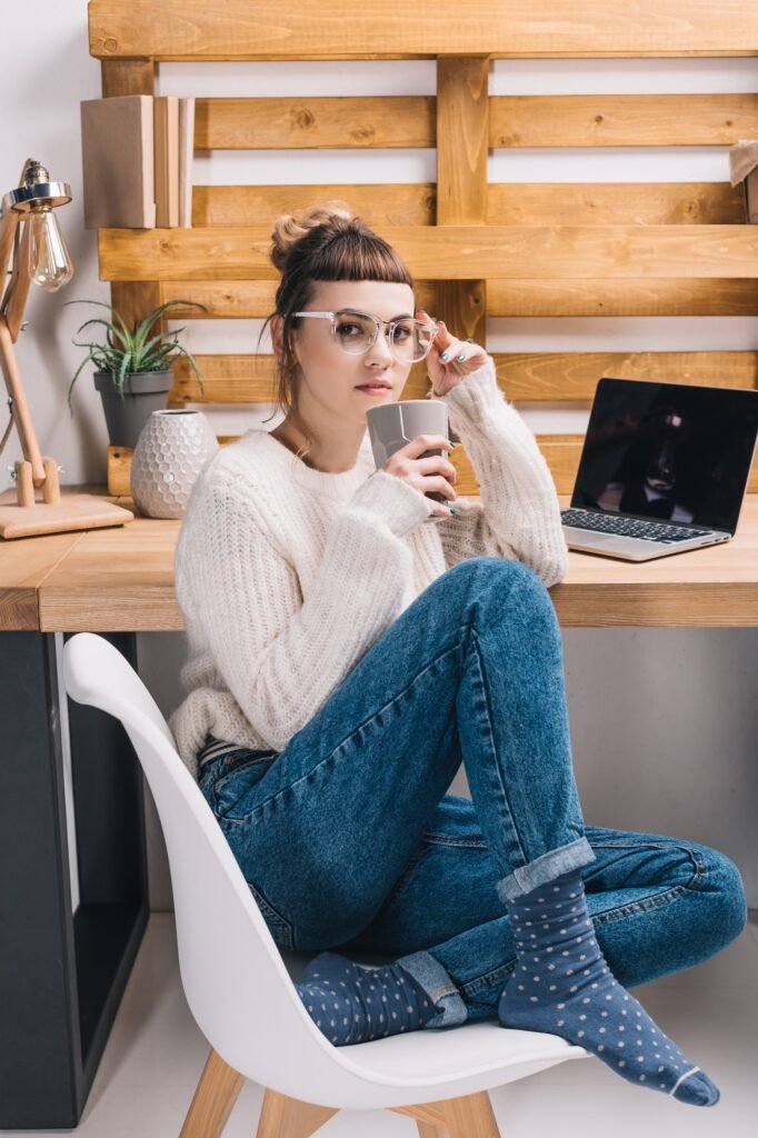 office worker sitting on chair and drinking tea