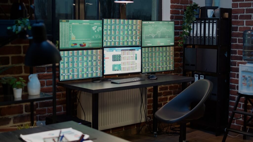 Empty office with stock market prices changing on multiple monitors