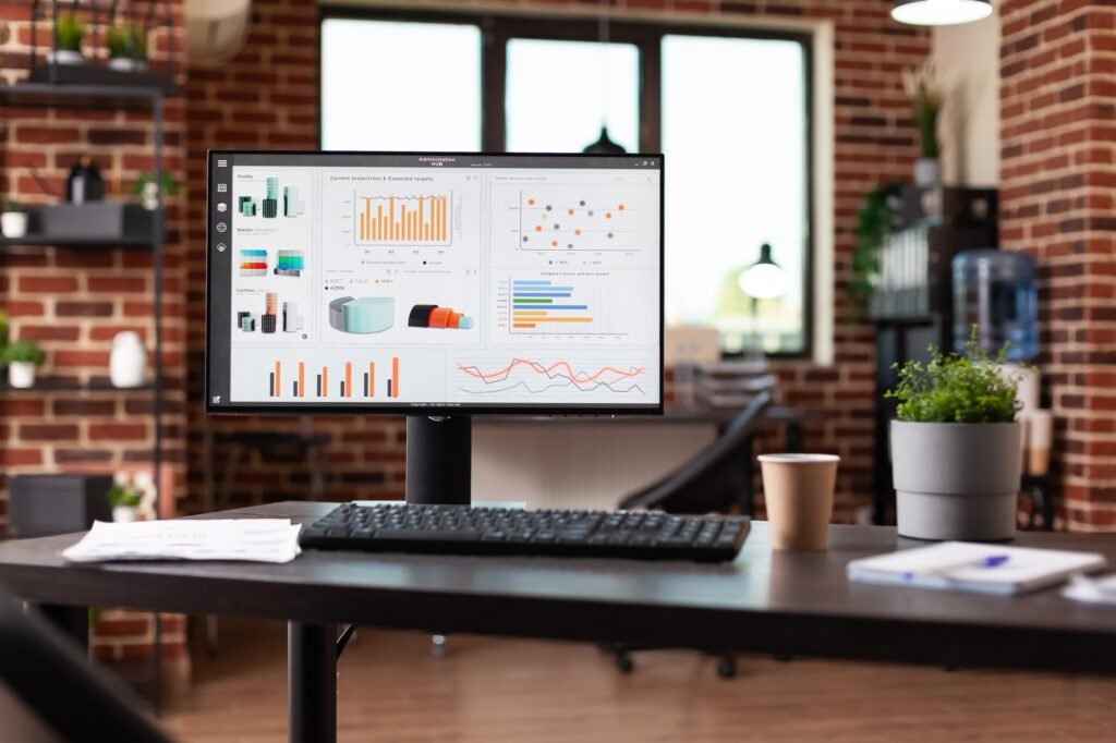 Nobody in office with business data charts on monitor