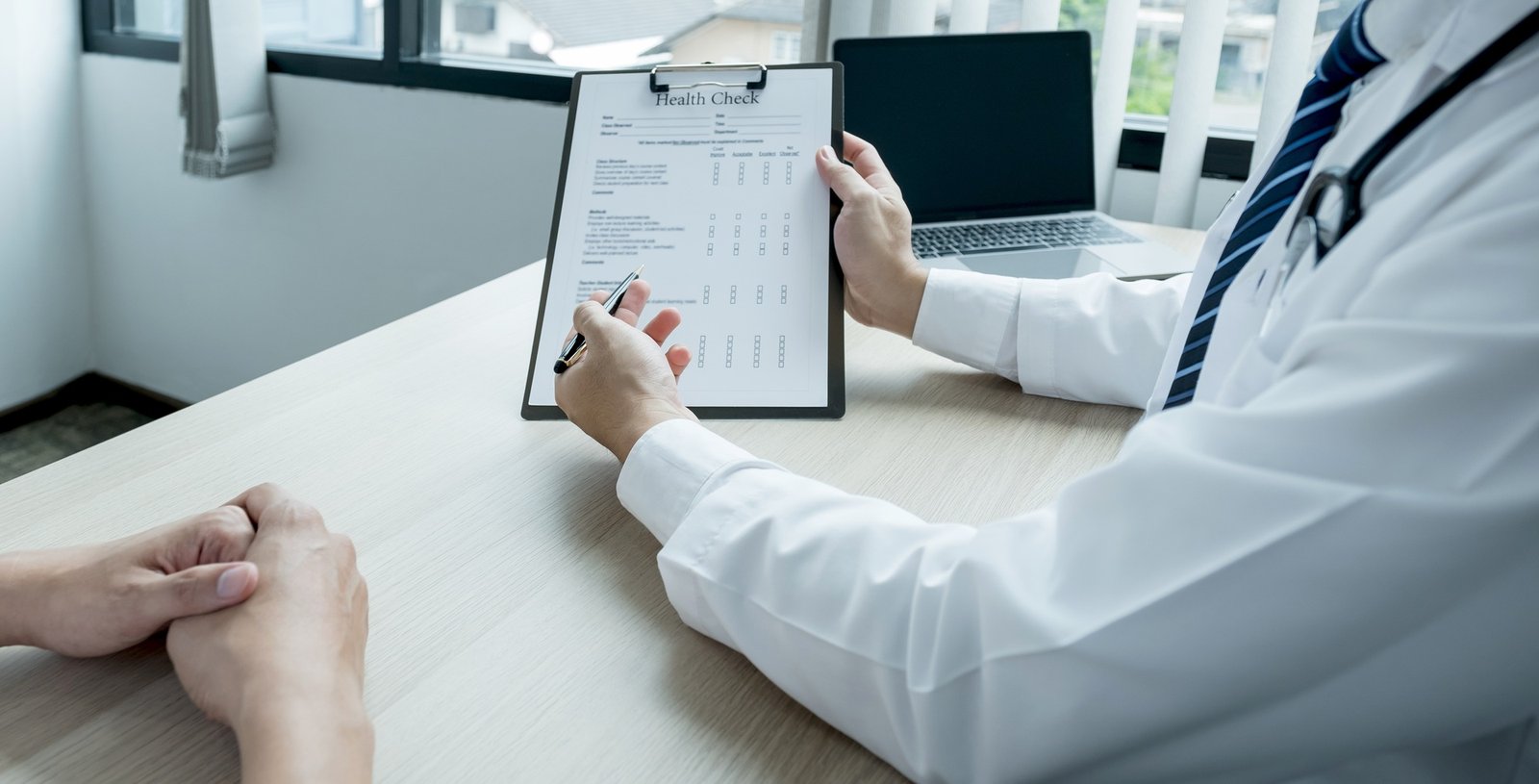 The doctor hand write report and explained the health examination results to the patient