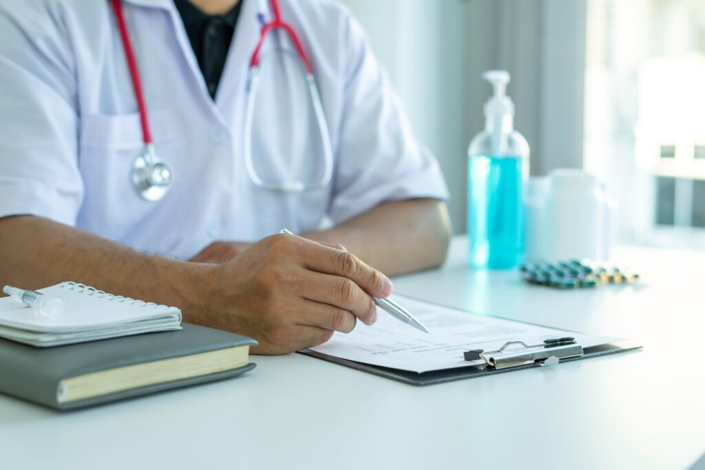 The doctor is reading a checklist of the results of the patient's health check to plan the treatment